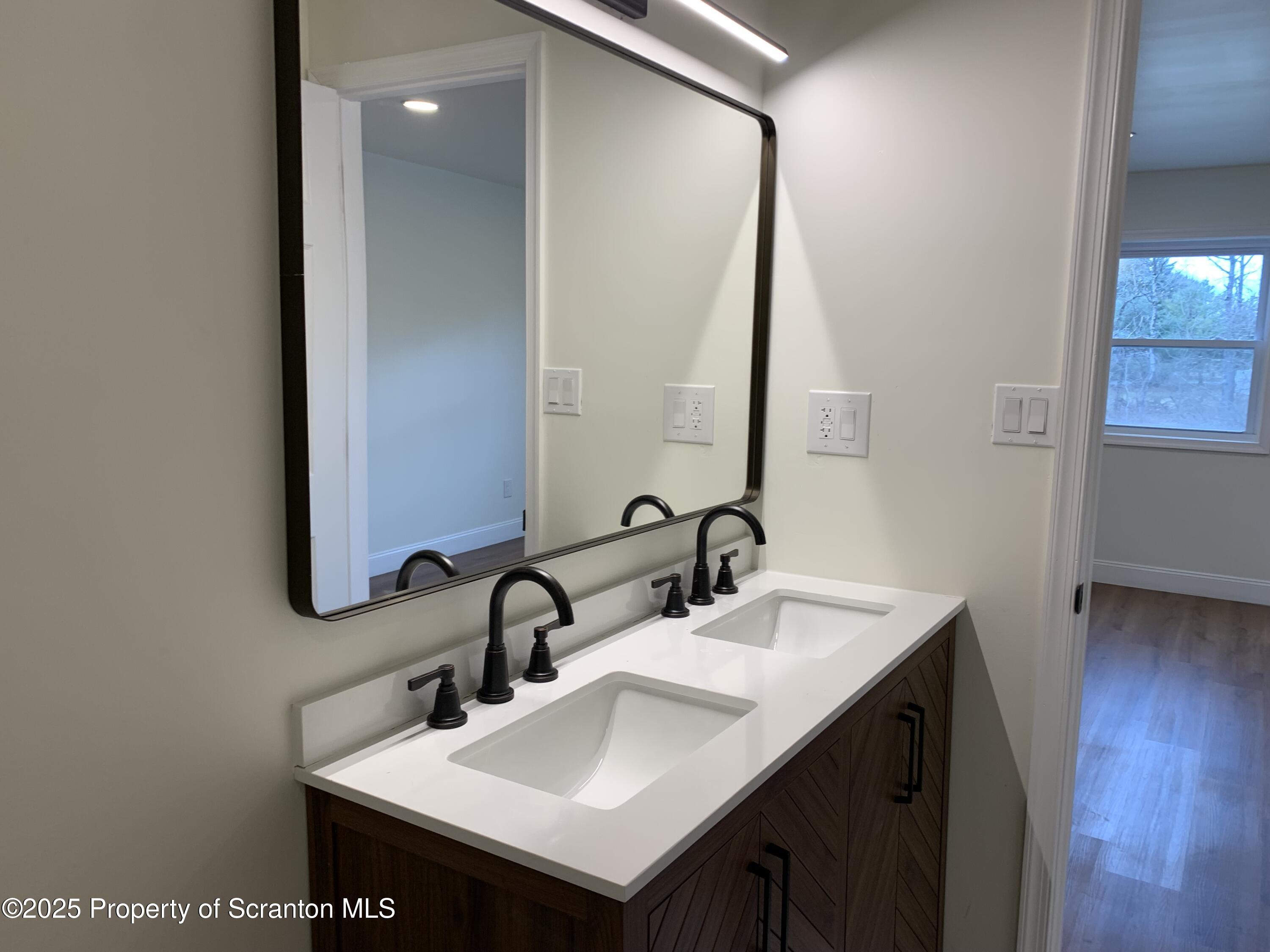 318 Simrell Road Clarks Summit, PA 18411 - Photo 28 of 30 a bathroom with a sink and a mirror