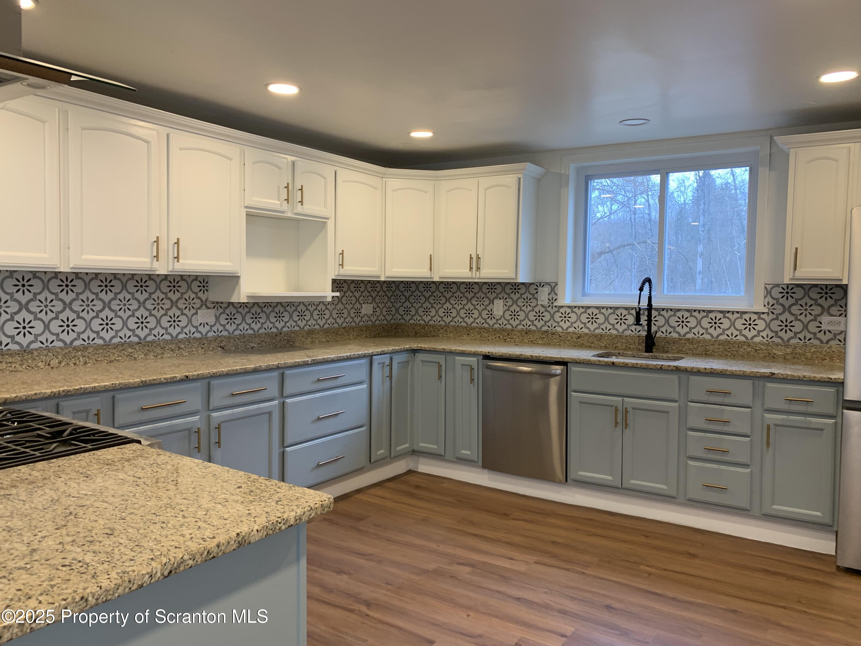318 Simrell Road Clarks Summit, PA 18411 - Photo 4 of 30 a kitchen with granite countertop a sink and cabinets