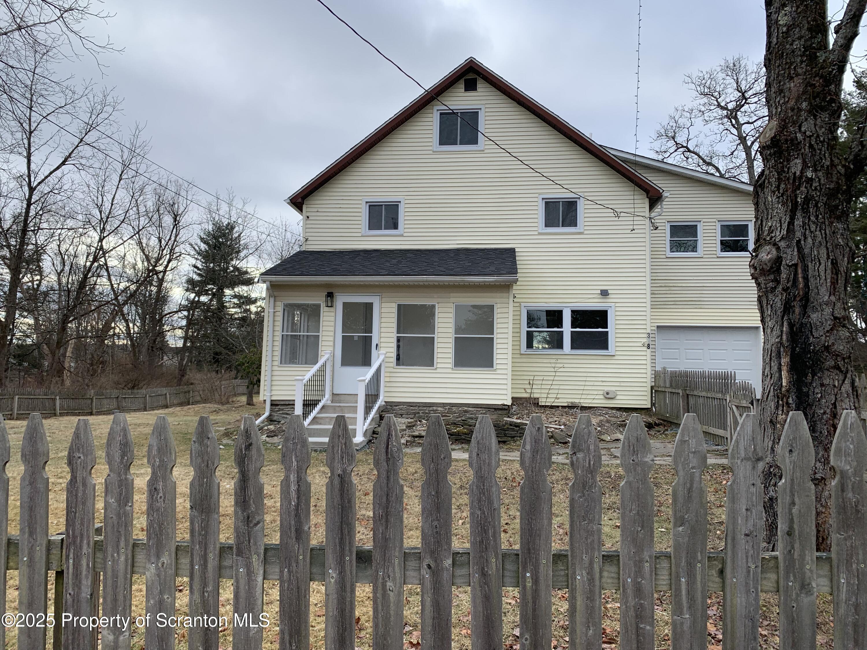 318 Simrell Road Clarks Summit, PA 18411 - Photo 5 of 30 a front view of a house with wooden fence