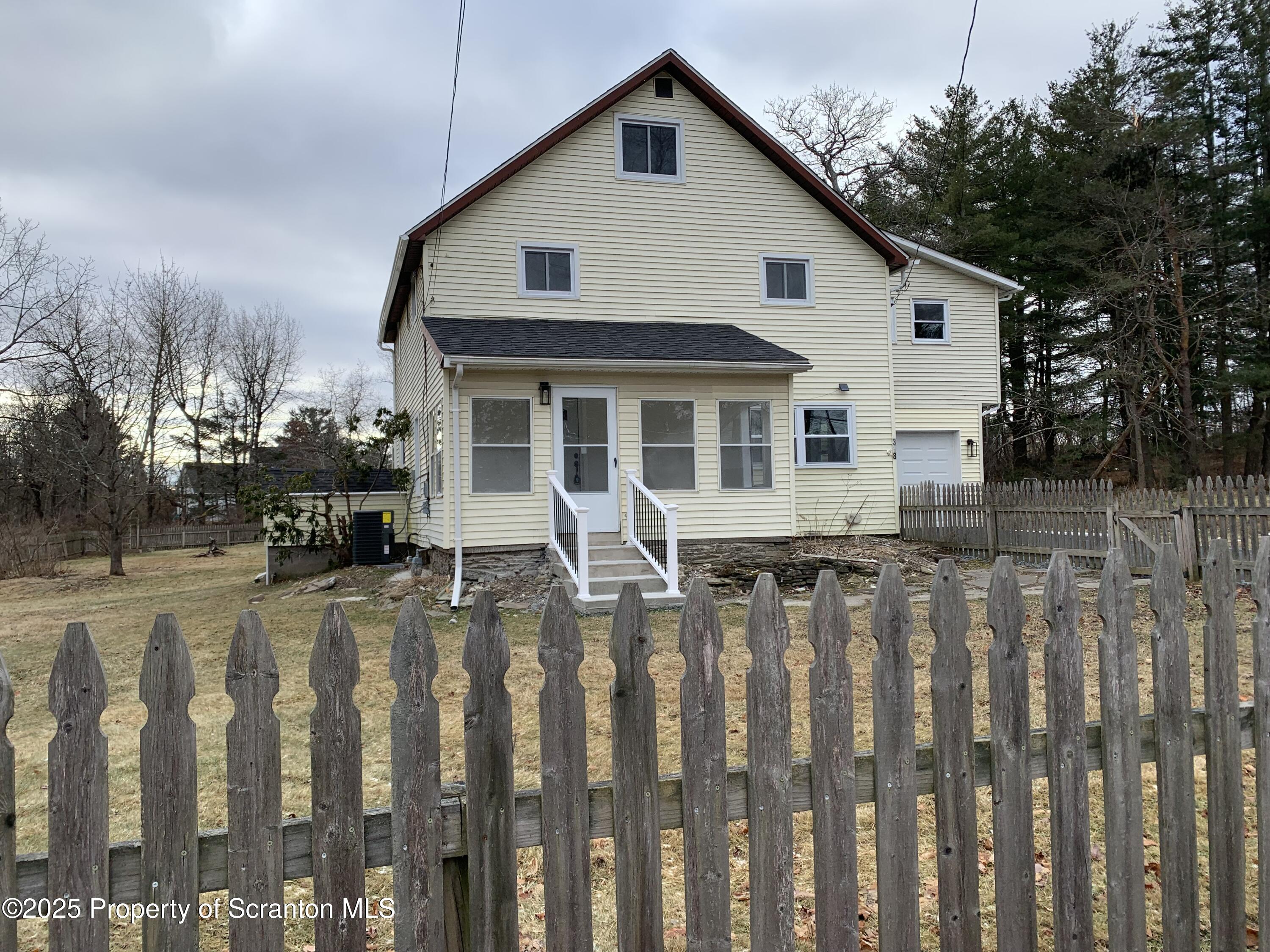 318 Simrell Road Clarks Summit, PA 18411 - Photo 6 of 30 a front view of a house with wooden fence