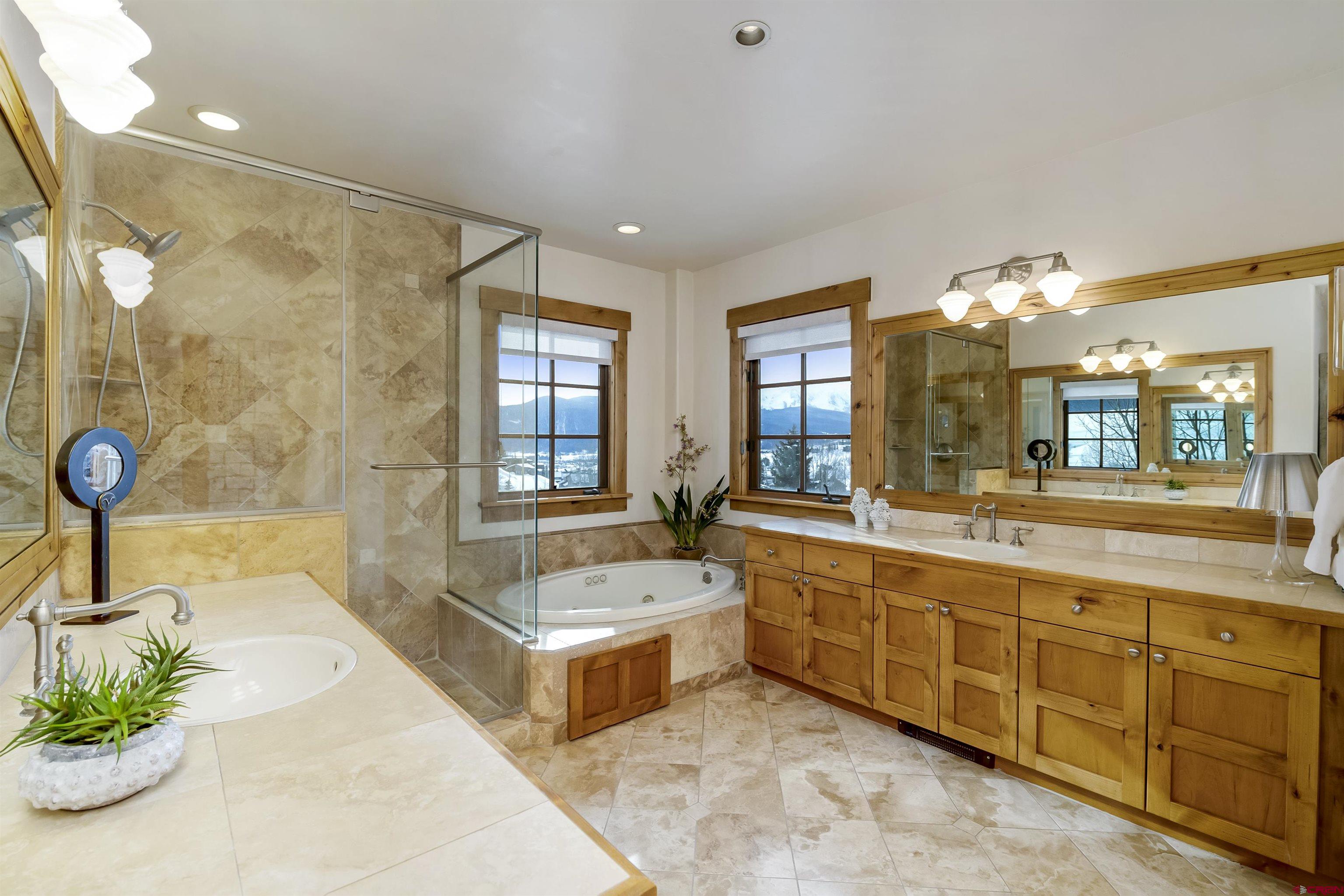 14 Hunter Hill Road, Unit A204 Crested Butte, CO 81225 - Photo 18 of 36 a spacious bathroom with a tub sink shower and mirror