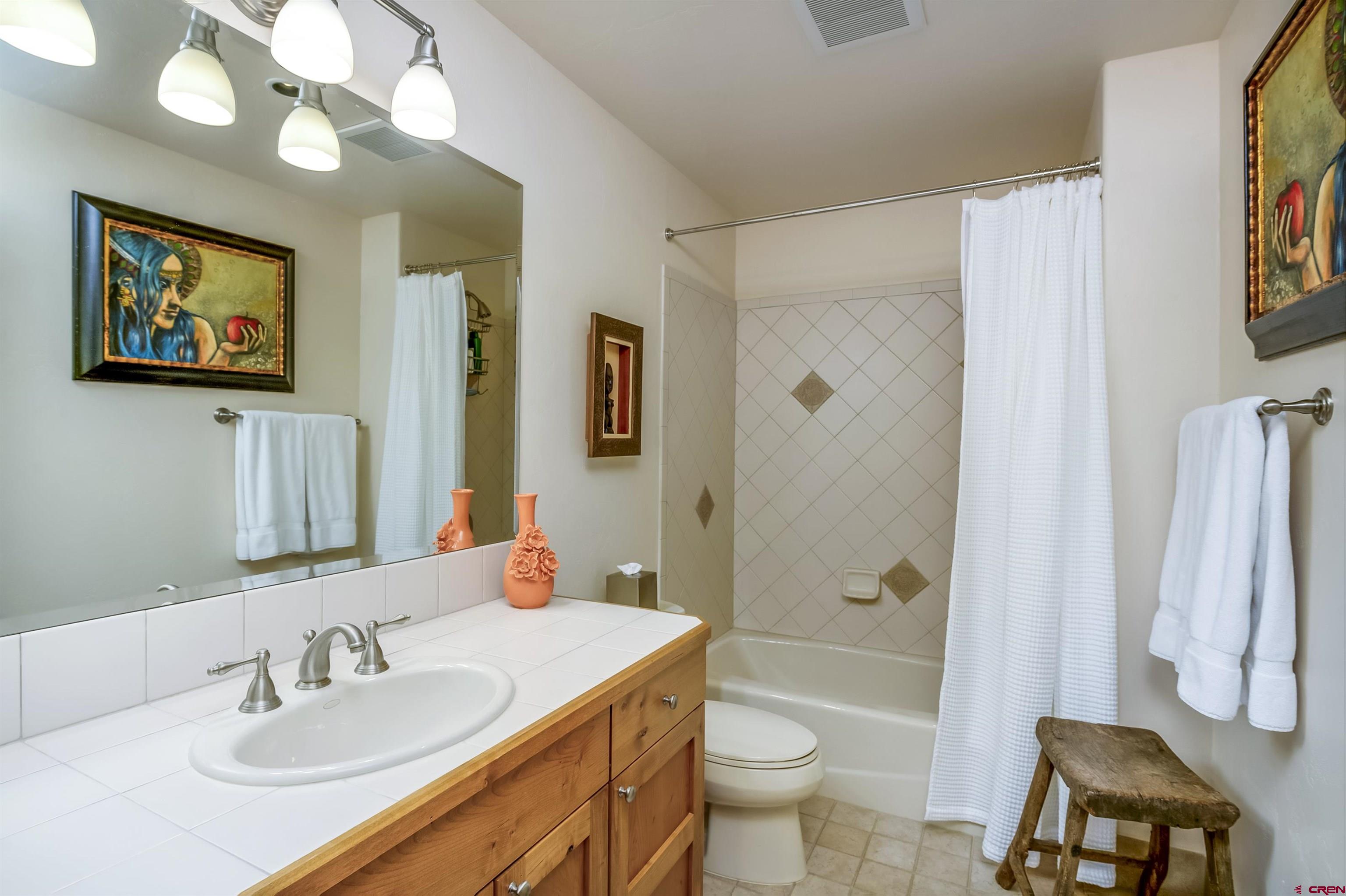 14 Hunter Hill Road, Unit A204 Crested Butte, CO 81225 - Photo 23 of 36 a bathroom with a granite countertop sink toilet and shower