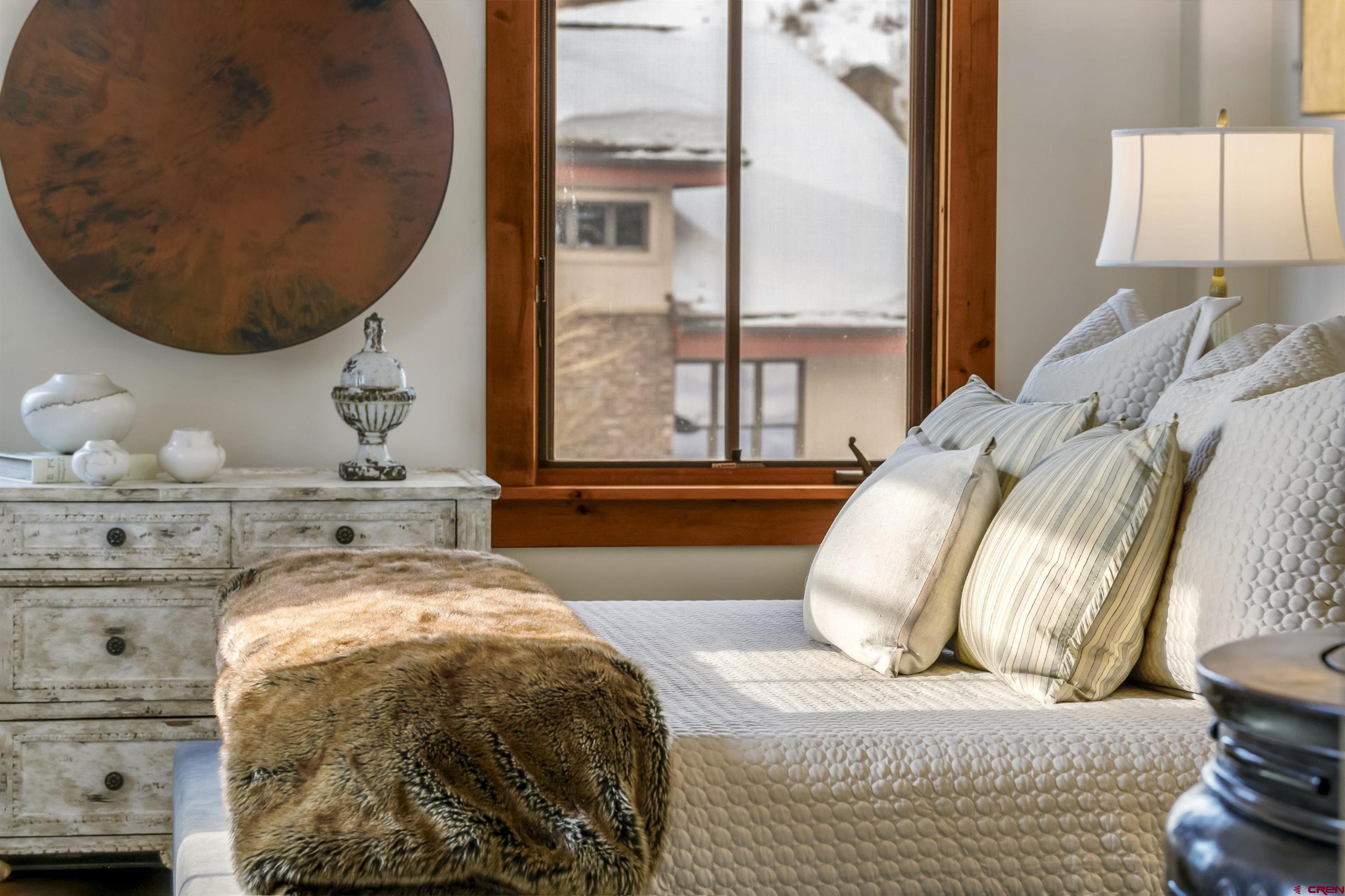 14 Hunter Hill Road, Unit A204 Crested Butte, CO 81225 - Photo 24 of 36 a spacious bedroom with a bed and window