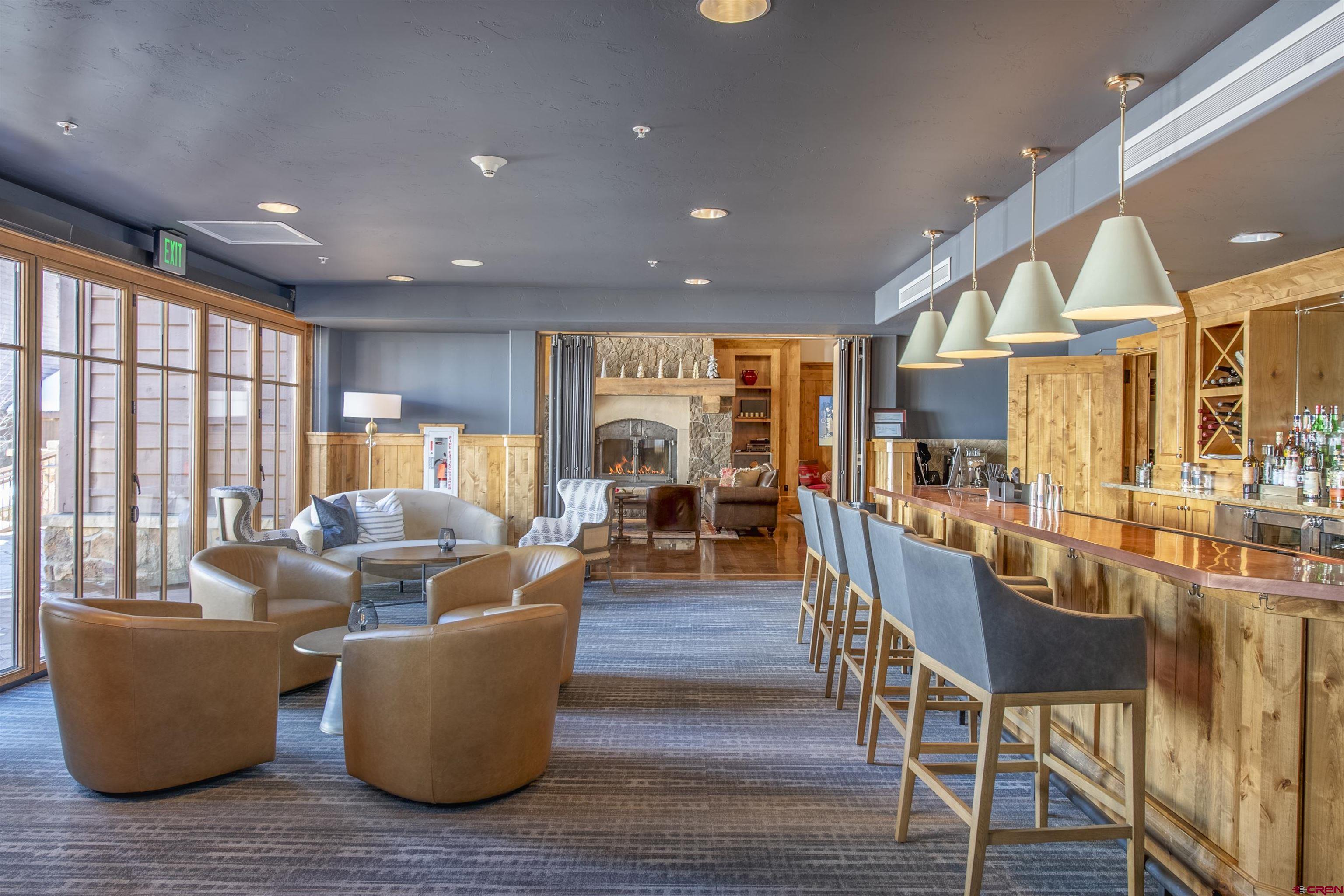 14 Hunter Hill Road, Unit A204 Crested Butte, CO 81225 - Photo 29 of 36 a living room with couches a coffee table and chairs with wooden floor