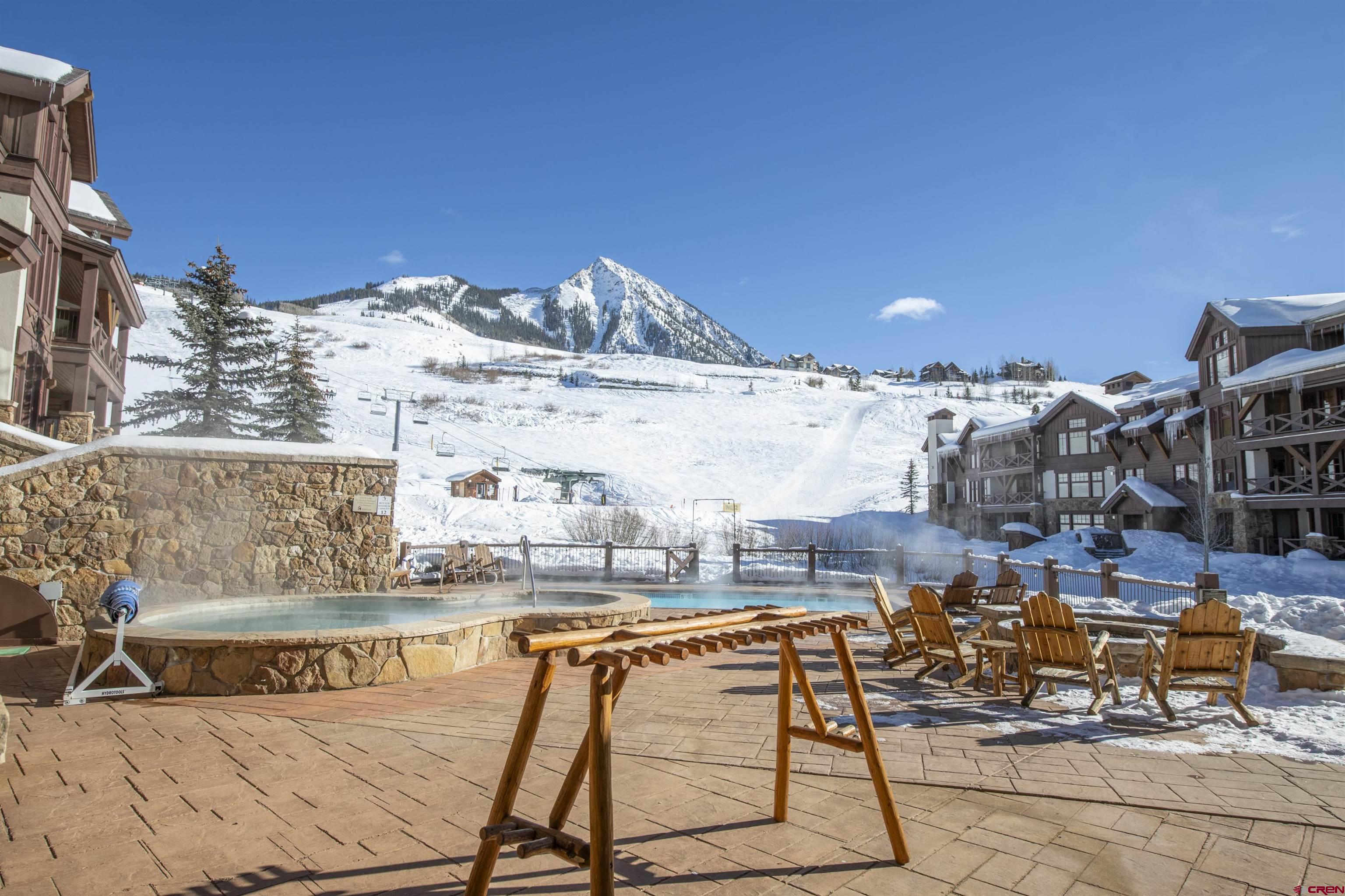 14 Hunter Hill Road, Unit A204 Crested Butte, CO 81225 - Photo 31 of 36 a view of a swimming pool with outdoor seating space