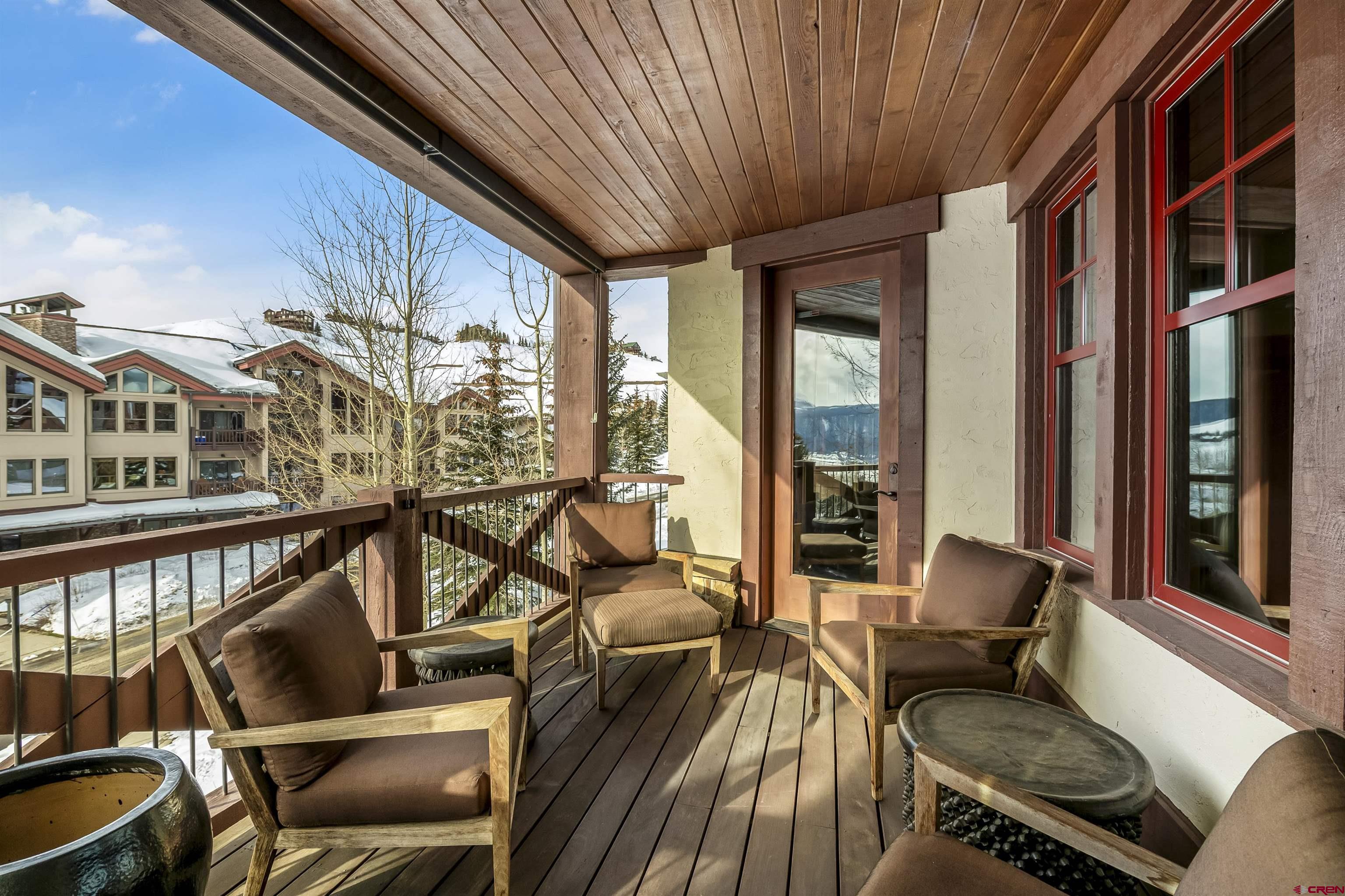 14 Hunter Hill Road, Unit A204 Crested Butte, CO 81225 - Photo 4 of 36 a living room with furniture floor to ceiling windows and wooden floor