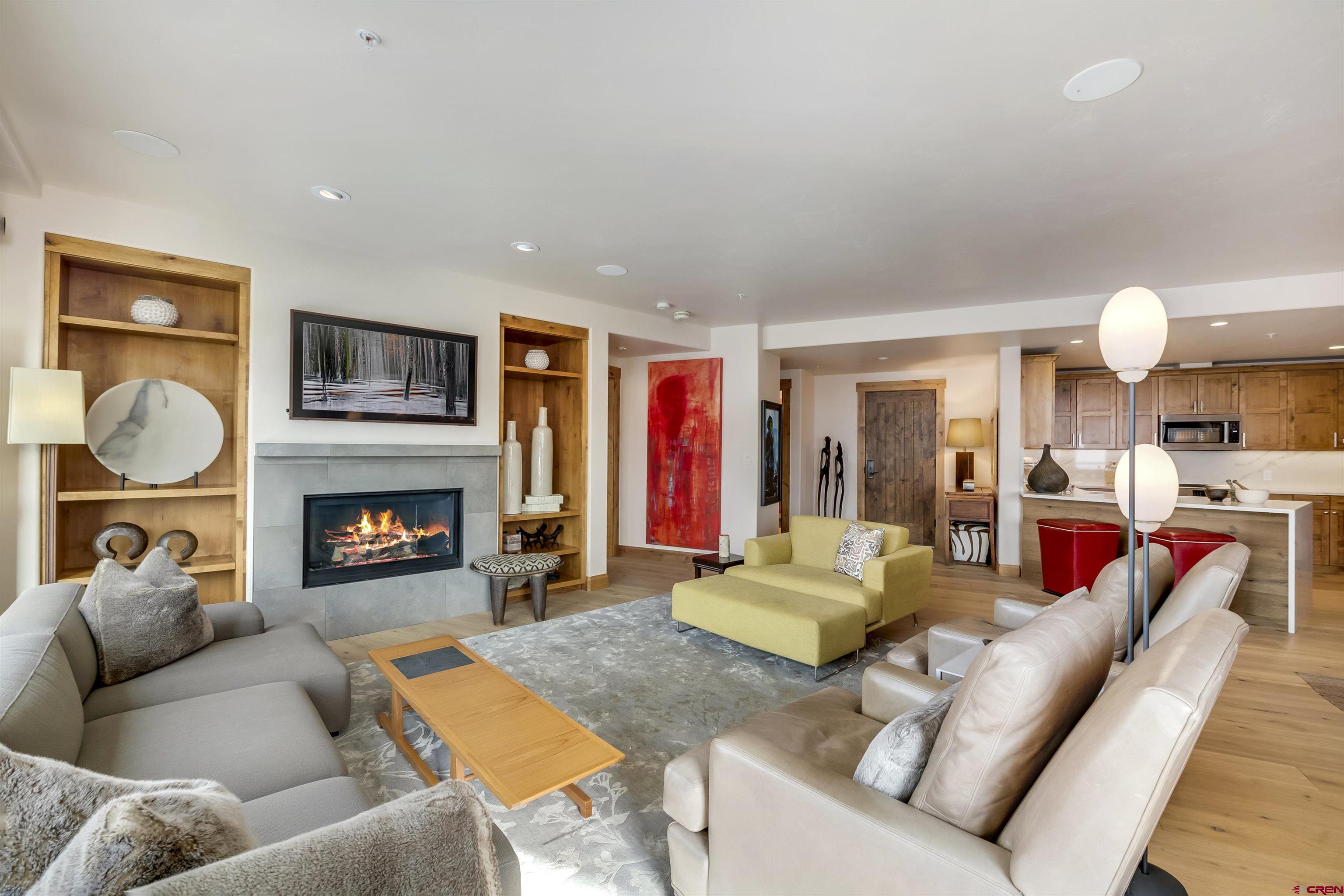 14 Hunter Hill Road, Unit A204 Crested Butte, CO 81225 - Photo 5 of 36 a living room with furniture fireplace and flat screen tv
