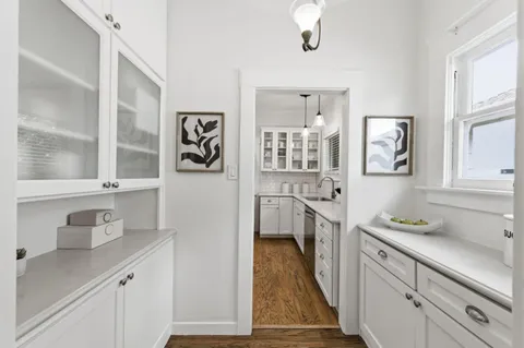 a kitchen with a refrigerator a sink and wooden cabinets