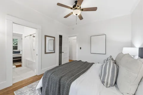 a bedroom with a bed and a chandelier