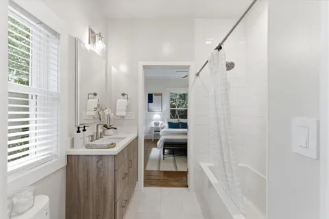 a en suite bathroom with a double vanity sink a mirror and a shower