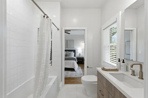 a bathroom with a sink a toilet and shower