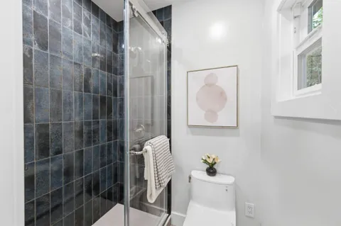 a bathroom with a sink mirror and toilet