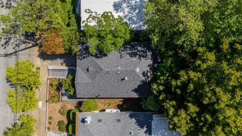 an aerial view of a house with a yard swimming pool