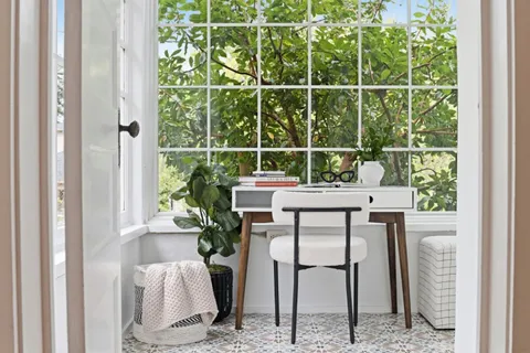 a dining room with furniture and a window