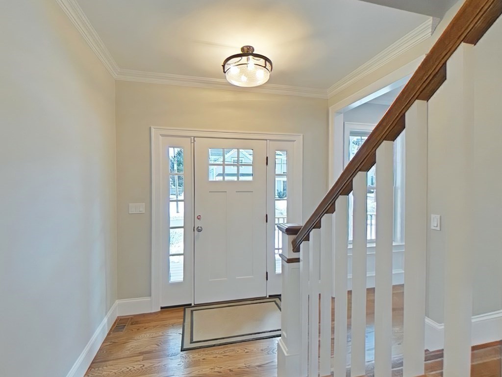 65 Emerson Road Needham, MA 02492 - Photo 11 of 37 a view of an entryway with wooden floor and stairs