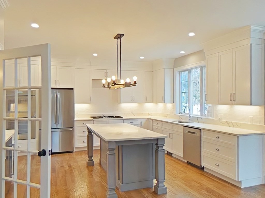 65 Emerson Road Needham, MA 02492 - Photo 5 of 37 a kitchen with a sink stainless steel appliances and cabinets