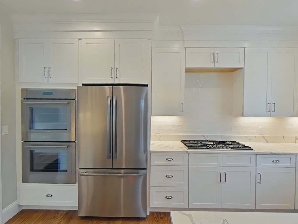 65 Emerson Road Needham, MA 02492 - Photo 6 of 37 a kitchen with cabinets and stainless steel appliances
