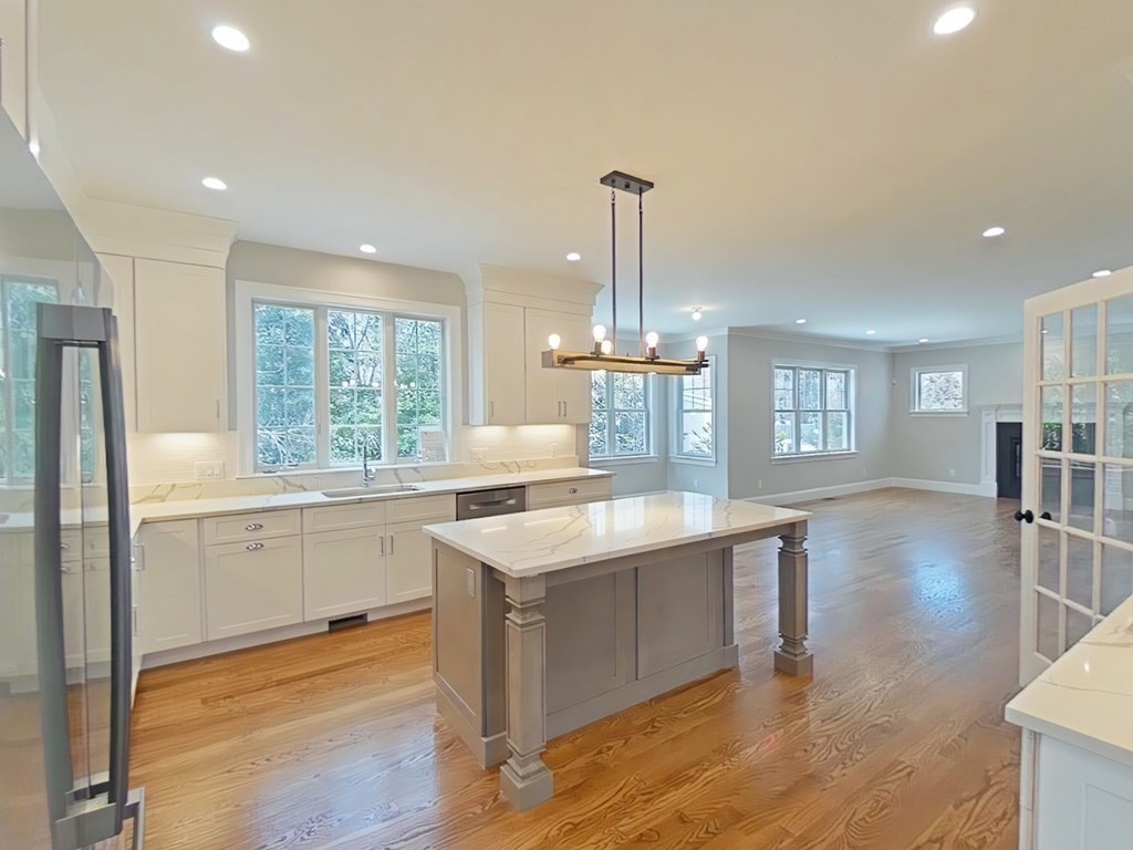 65 Emerson Road Needham, MA 02492 - Photo 7 of 37 a kitchen with stainless steel appliances granite countertop a sink stove and refrigerator