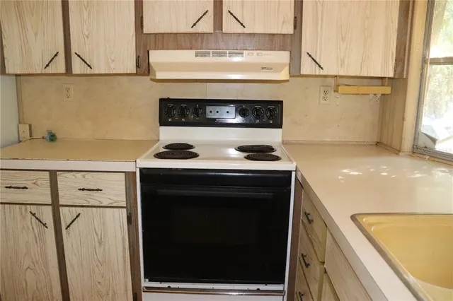 a kitchen with a stove and a sink