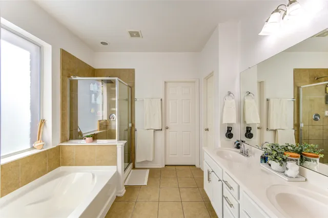 a bathroom with a double vanity sink mirror and double