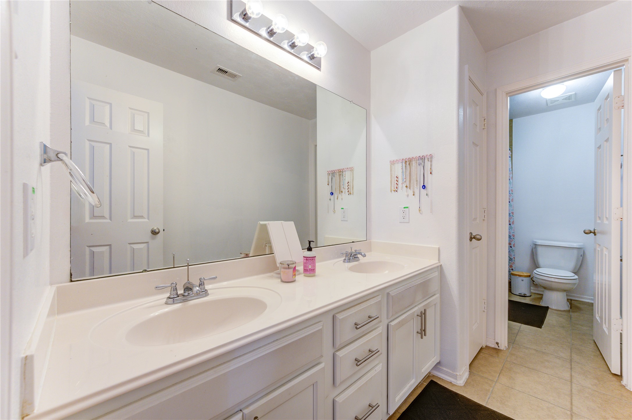 25210 Hazel Ranch Drive Katy, TX 77494 - Photo 29 of 45 a bathroom with a double vanity sink toilet and a mirror