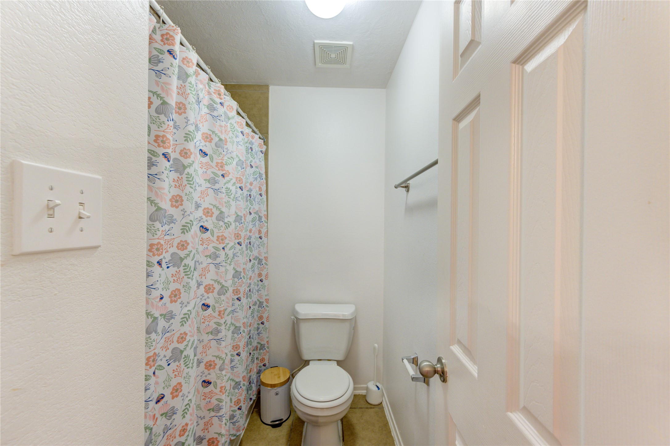 25210 Hazel Ranch Drive Katy, TX 77494 - Photo 30 of 45 a white toilet sitting next to a shower curtain