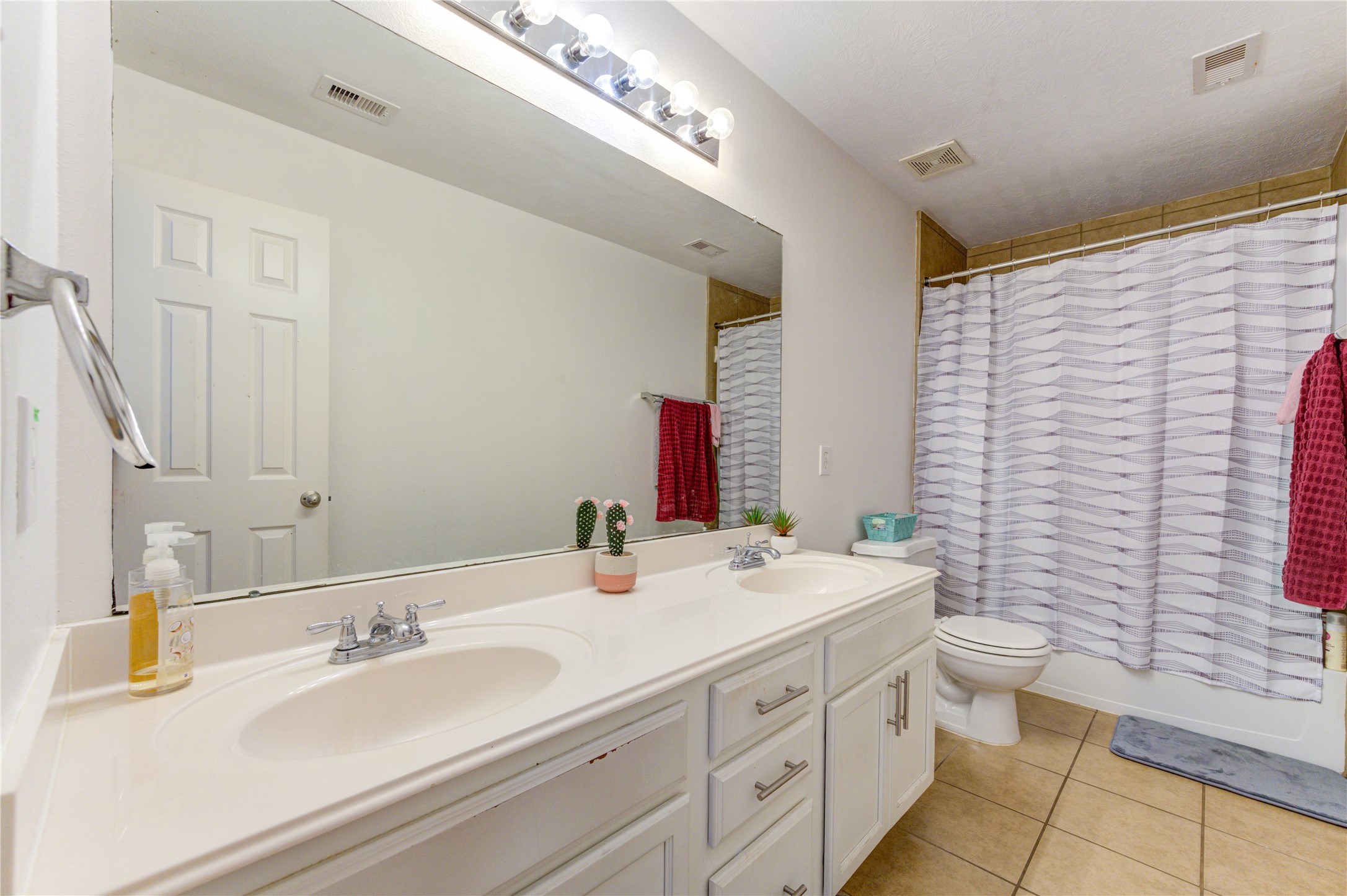 25210 Hazel Ranch Drive Katy, TX 77494 - Photo 31 of 45 a bathroom with a double vanity sink mirror and toilet