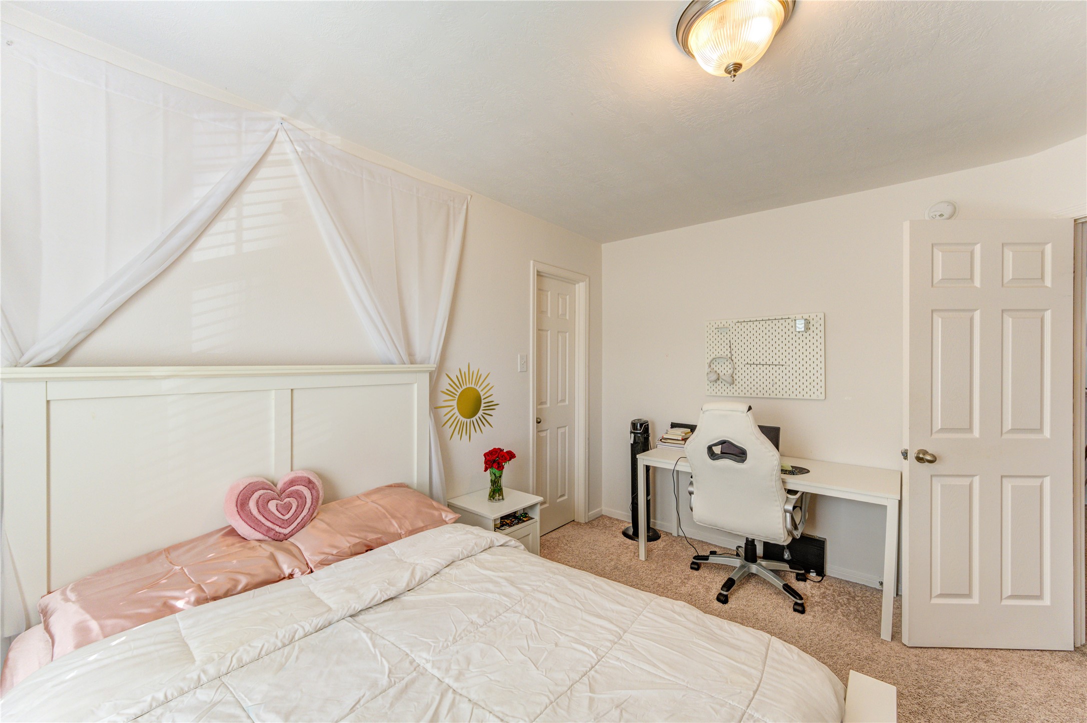 25210 Hazel Ranch Drive Katy, TX 77494 - Photo 35 of 45 a bedroom with a bed and a chandelier