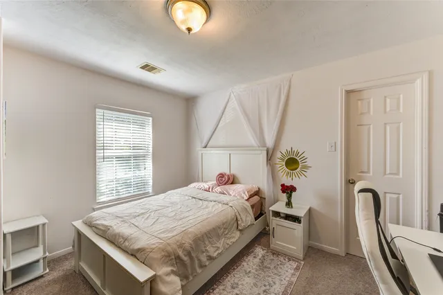 a bedroom with bed and a chandelier
