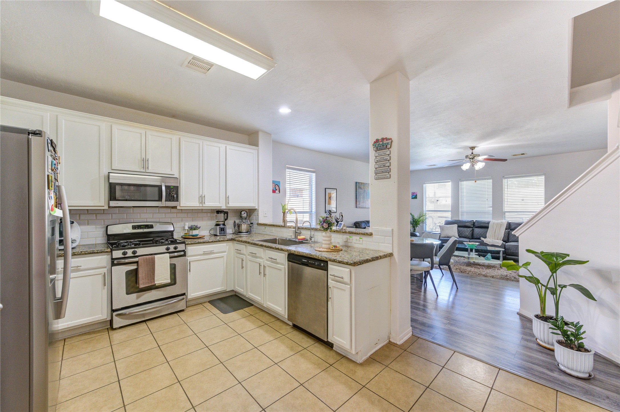 25210 Hazel Ranch Drive Katy, TX 77494 - Photo 7 of 45 a kitchen with stainless steel appliances granite countertop a stove top oven a sink a counter top space and cabinets