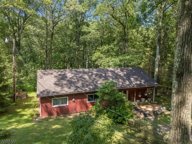 an aerial view of a house with a yard large tree table and chairs