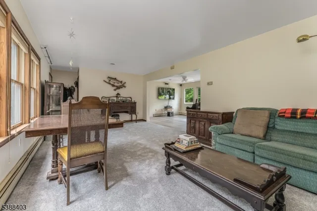 a living room with furniture a rug and a table