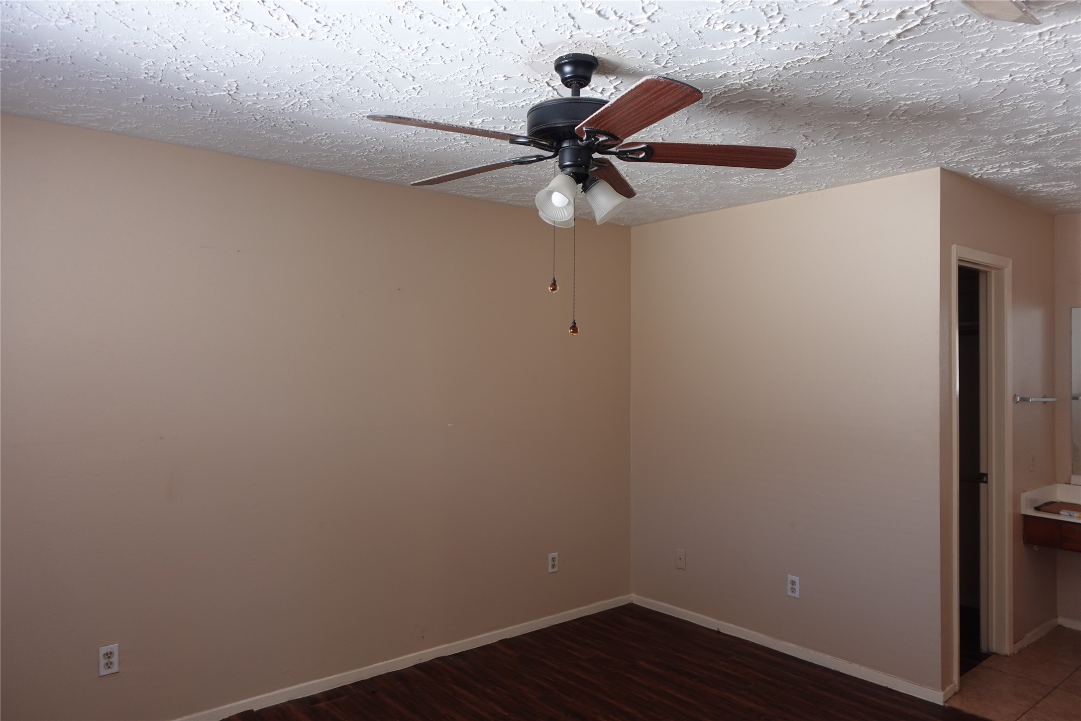 20027 Chipplegate Lane Humble, TX 77338 - Photo 20 of 32 a view of a small space with wooden floor and a ceiling fan