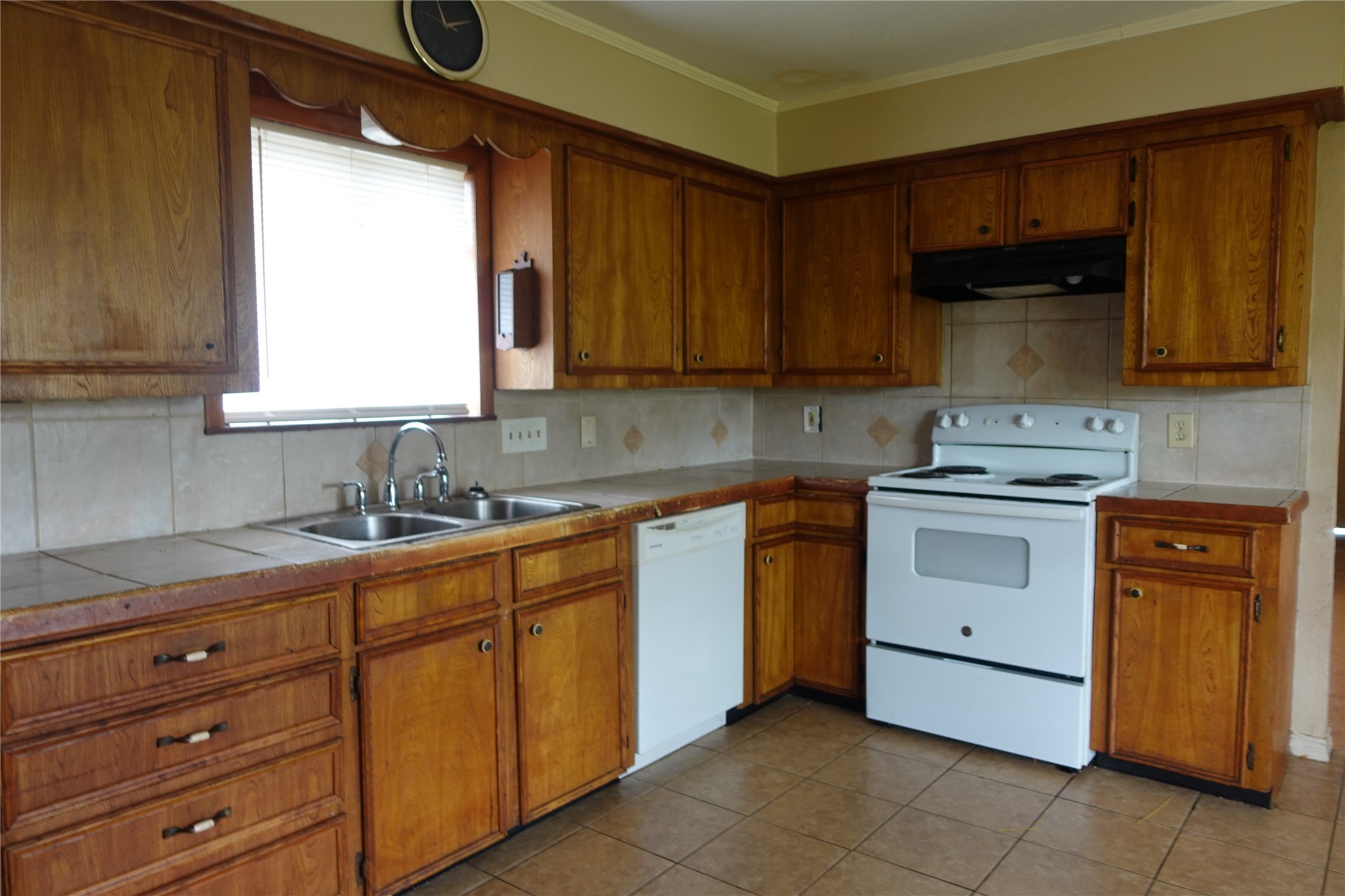 20027 Chipplegate Lane Humble, TX 77338 - Photo 9 of 32 a kitchen with cabinets appliances a sink and a window