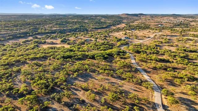an aerial view of residential houses with city view
