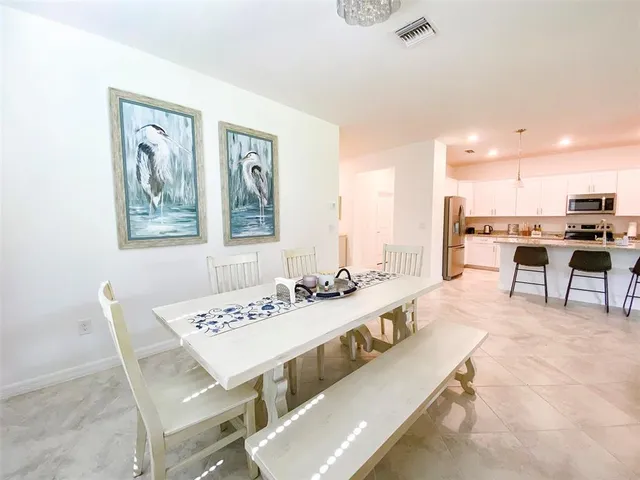 a living room with stainless steel appliances kitchen island granite countertop furniture and a kitchen view