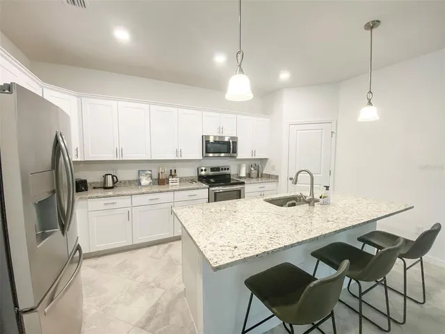 a kitchen with a refrigerator a stove a sink and a refrigerator