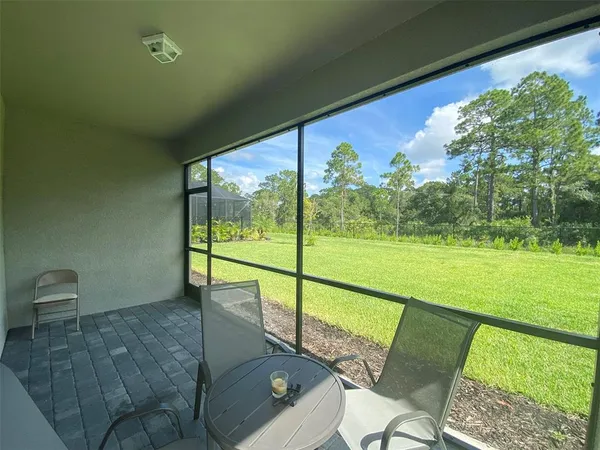 a view of a porch with furniture and garden