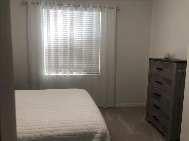 a bedroom with a bed and a closet