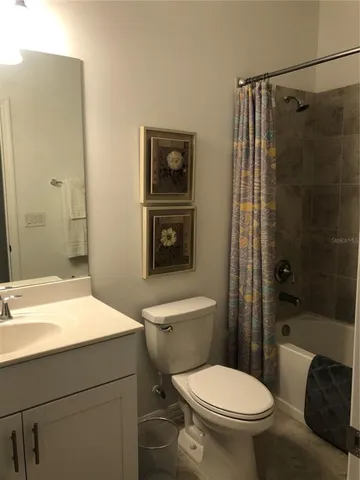 a bathroom with a toilet a sink and shower