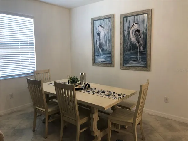 a view of a dining room that has a table and chairs in it