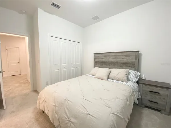 a large bed sitting in a bedroom and closet