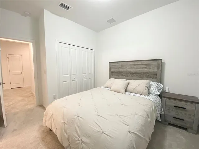 a large bed sitting in a bedroom and closet