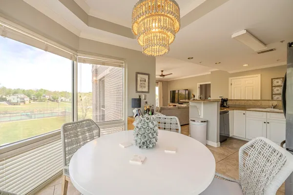 a large kitchen with a table and chairs