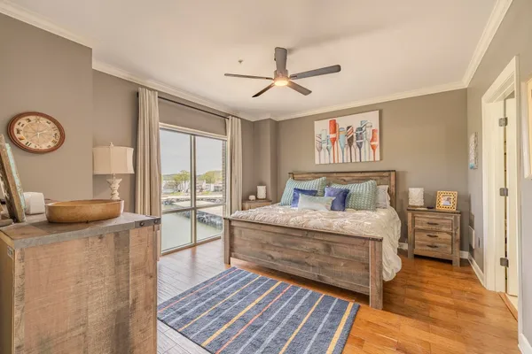 a spacious bedroom with a bed and wooden floor