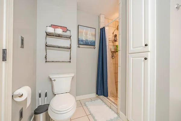 a white toilet sitting next to a bathroom sink