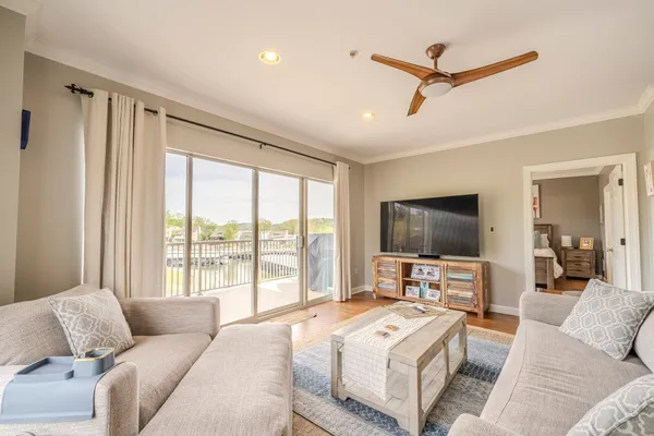 a bedroom with a bed television window and a flat screen television