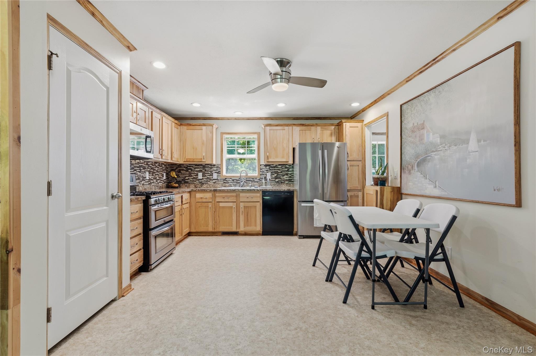 239-241 Fosler Road Highland, NY 12528 - Photo 32 of 42 Well-appointed kitchen featuring wood cabinetry, stainless steel appliances, mosaic tile backsplash, and recessed lighting