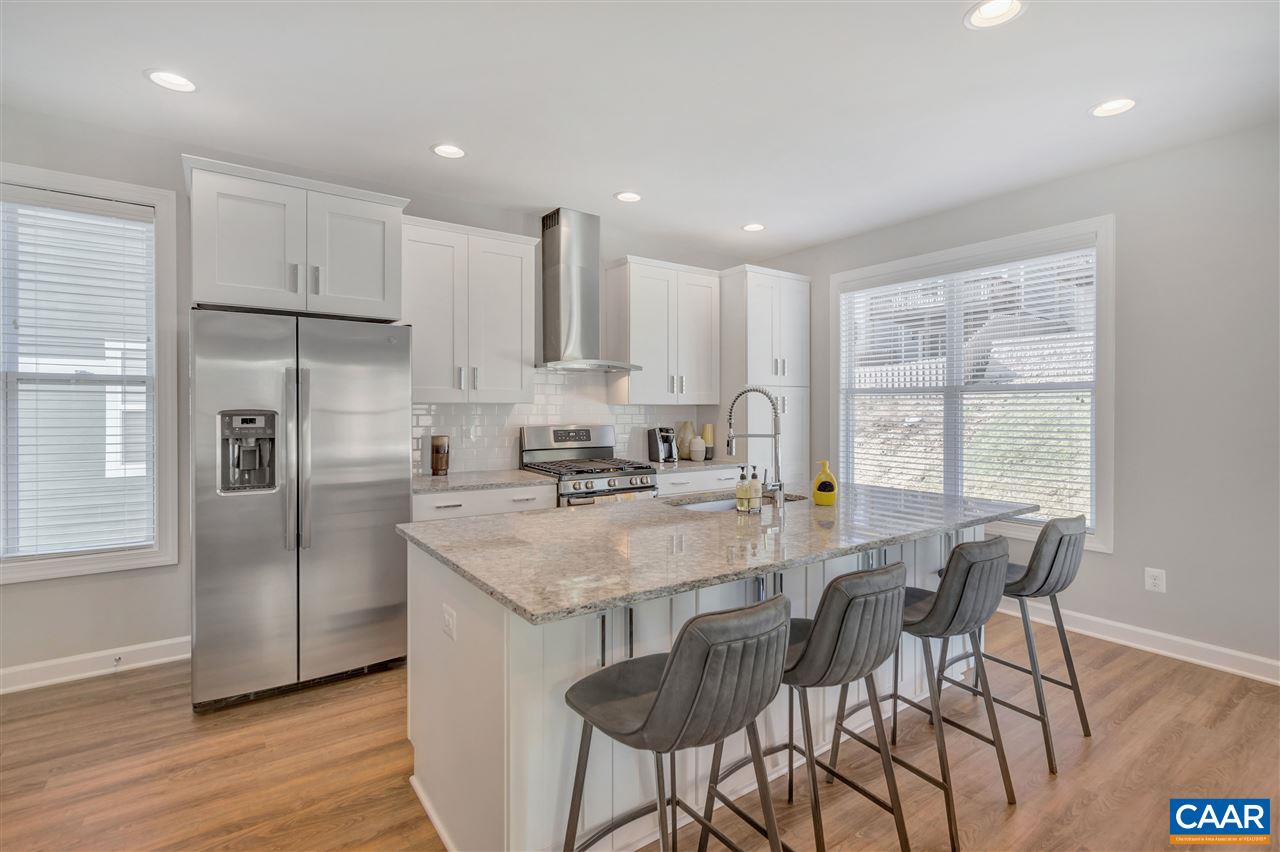 3146 Horizon Road Charlottesville, VA 22902 - Photo 8 of 20 a kitchen with stainless steel appliances granite countertop a stove a refrigerator a sink a dining table and chairs with wooden floor