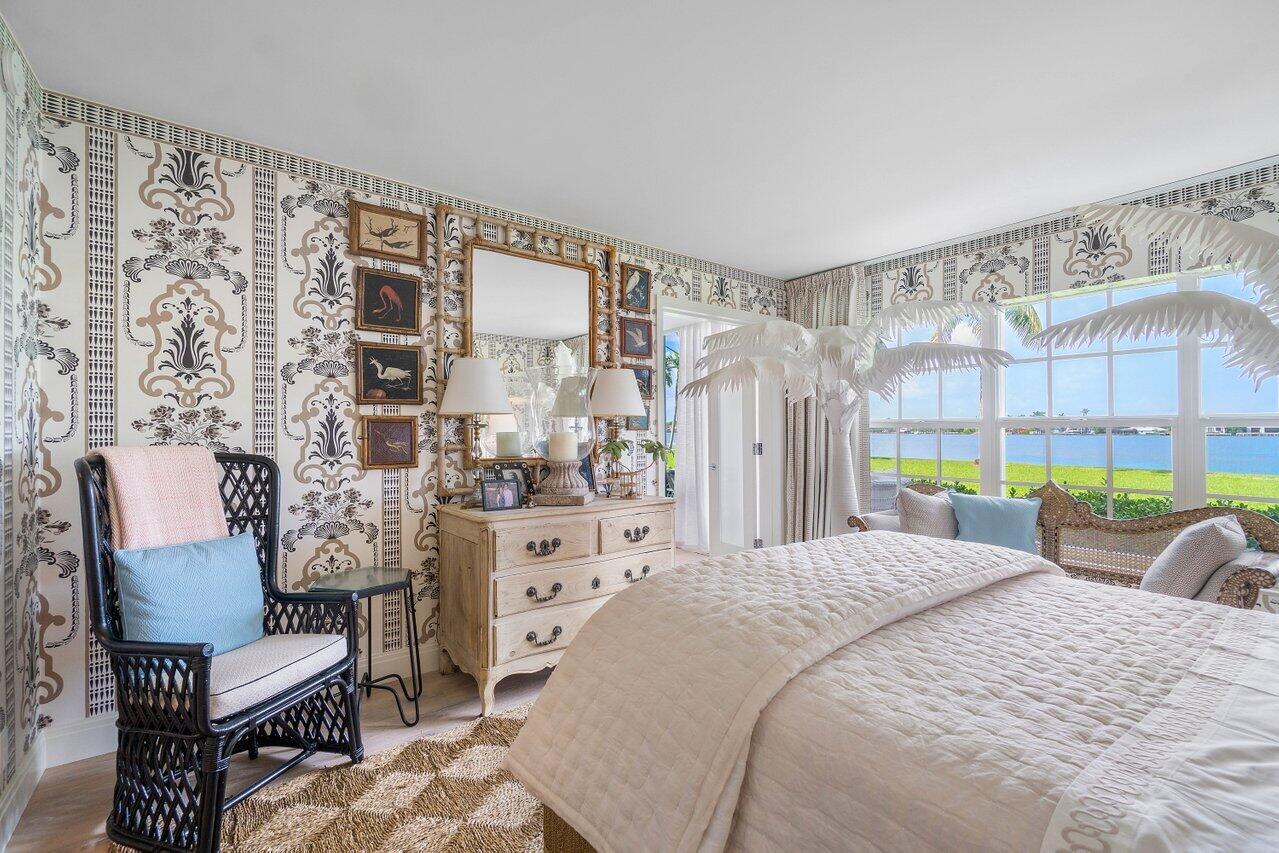 2170 Ibis Isle Road, Unit 3 Palm Beach, FL 33480 - Photo 8 of 12 a bedroom with a bed wooden floor and a large window